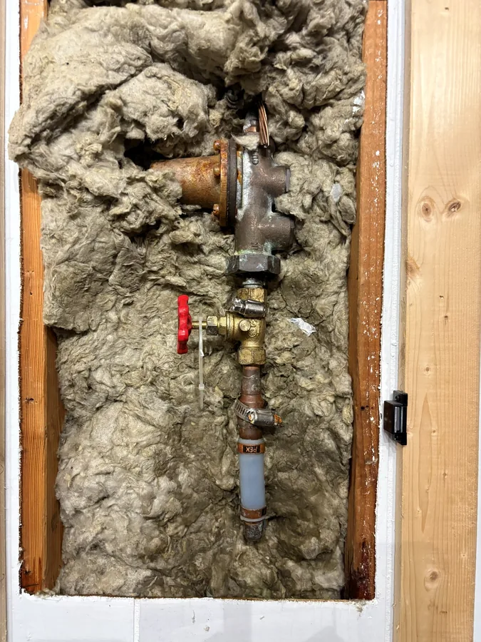 The old main shutoff valve in the open wall