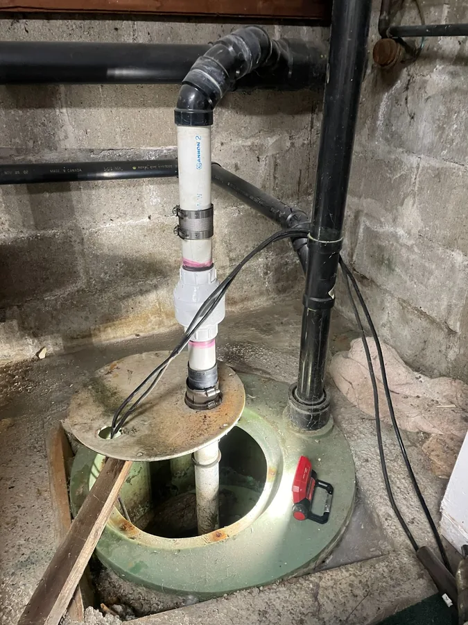 The new sump pump and pipework fitted in the pit